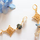 Universo. Aretes huggies con nudo de bruja, calcopiritas y herkimers.