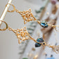 Universo. Aretes huggies con nudo de bruja, calcopiritas y herkimers.